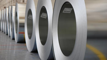 The image shows rolls of steel
